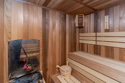 a wooden sauna with a tub and aburningificialificialificialificialificialificial at Sunny Paradise ll in Kiten