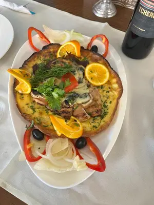 a plate of food on a table with a plate of food at Sunny Paradise ll in Kiten