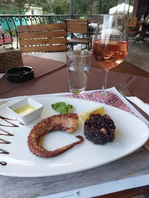 a plate with a sausage and cheese and a glass of wine at Sunny Paradise ll in Kiten
