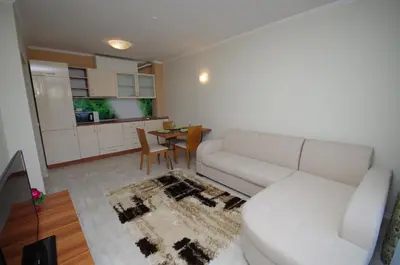 a living room with a white couch and a table at Lily Beach Resort in Sozopol