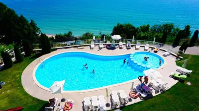an overhead view of a swimming pool with people in the water at Плажни Апартаменти Силвър Бийч - Silver Beach Sea Apartments in Byala