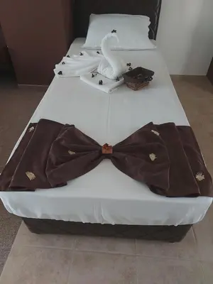 a bed with a dress and a bow tie on it at Diamond Kiten in Kiten