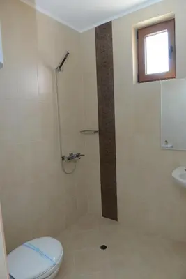 a bathroom with a shower with a toilet and a sink at Diamond Kiten in Kiten