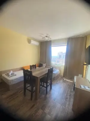 a room with a table and chairs and a bed at AMADEUS 5 in Sunny Beach
