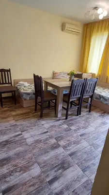 a room with a table and chairs and a room with beds at AMADEUS 5 in Sunny Beach