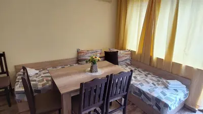 a dining room table with a vase of flowers on it at AMADEUS 5 in Sunny Beach