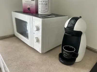 a coffee maker sitting next to a microwave at ApartHotel Asparuh Studio3 in Varna City