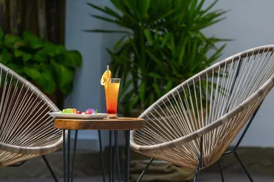 two chairs and a table with a drink on it at JI HOTEL in Sozopol
