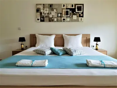 a large bed with pillows on top of it at St George Apartcomplex in Shkorpilovtsi