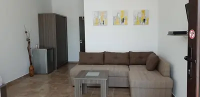 a living room with a couch and a table at St George Apartcomplex in Shkorpilovtsi