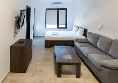 a living room with a couch and a bed at St George Apartcomplex in Shkorpilovtsi