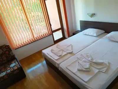 a bedroom with two beds with towels on them at Adri Guest House in Nesebar