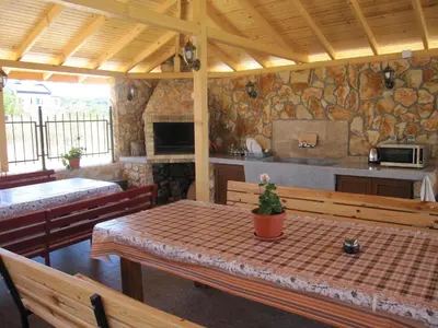 a dining room with a table and a kitchen at Neli Sea Villa in Sozopol