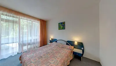 a bedroom with a bed and a large window at Elmar Hotel in Kiten