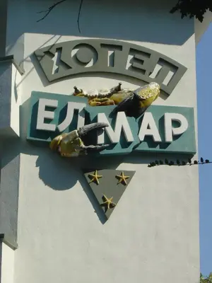 a sign on the side of a building at Elmar Hotel in Kiten