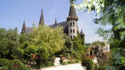a building with a garden in front of it at Sozopoli Hills Simeonov Apartments in Sozopol