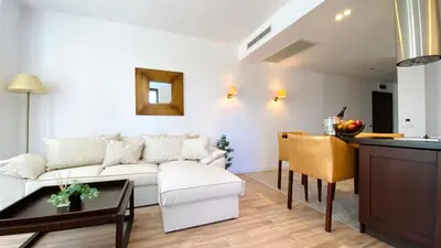 a living room with a white couch and a table at ROYAL BEACH - Modern & Private Apartments in center Sunny Beach in Sunny Beach
