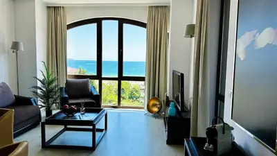 a living room with a view of the ocean at ROYAL BEACH - Modern & Private Apartments in center Sunny Beach in Sunny Beach