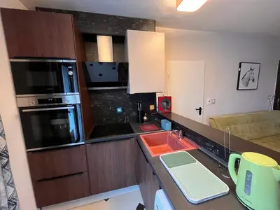 a small kitchen with a sink and a microwave at Botabara 312 Beach Front Apartment in Pomorie