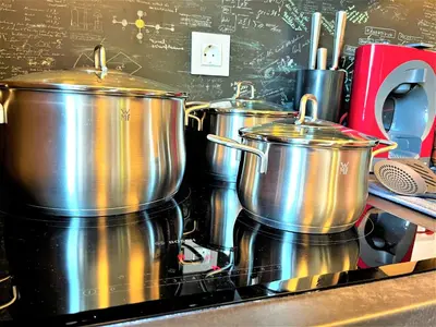 a group of pots on a stove in a kitchen at Botabara 312 Beach Front Apartment in Pomorie
