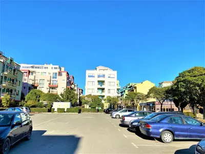 a parking lot with many cars parked in it at Botabara 312 Beach Front Apartment in Pomorie