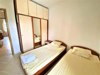 two beds in a small room with a mirror at Bravo 5 Apartments in Sunny Beach