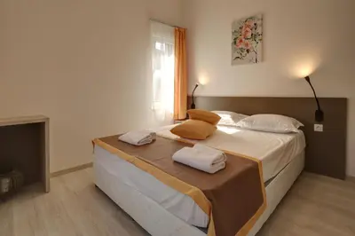a bedroom with a large bed with two pillows on it at Eco complex Zdravets near Varna in Zdravets