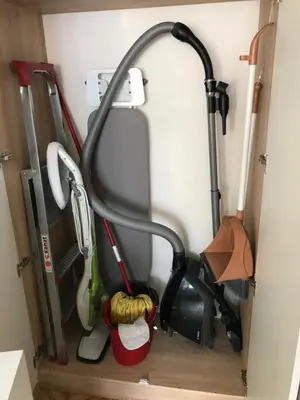 a rack of gardening tools in a closet at Familienapartment am Strand in Primorsko in Primorsko