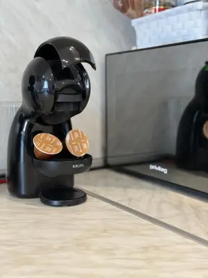 a coffee maker holding cookies in front of a tv at Vip Luxury APARTMENT in Burgas City