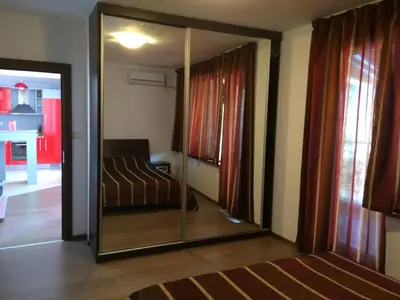 a bedroom with a mirror and a bed in it at 2-х комнатные апартаменты в г.Поморие Болгария in Pomorie