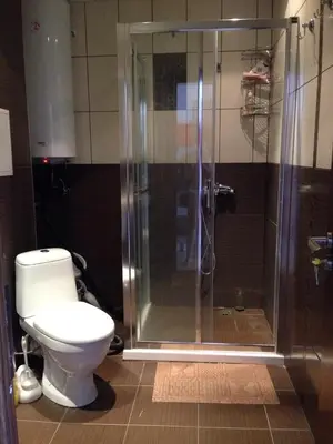 a bathroom with a toilet and a glass shower at 2-х комнатные апартаменты в г.Поморие Болгария in Pomorie