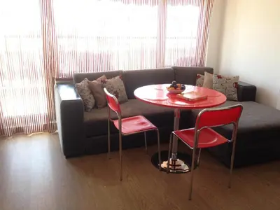 a living room with a couch and a table and chairs at 2-х комнатные апартаменты в г.Поморие Болгария in Pomorie