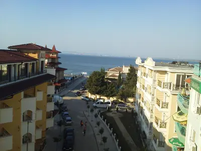 a view of a city street with buildings and the ocean at Krasi Hotel in Ravda