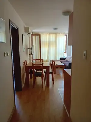 a living room with a table and chairs and a couch at Panorama Vigo Nesebar in Nesebar
