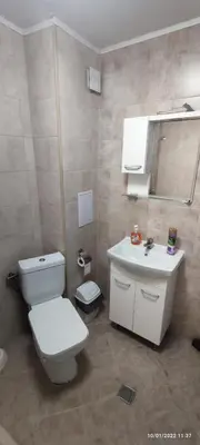a bathroom with a white toilet and a sink at Samuil Apartments - Central Burgas in Burgas City