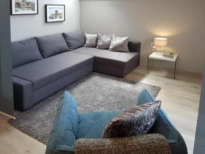 a living room with a blue couch and a table at SP Luxury Loft 28 in Ravda