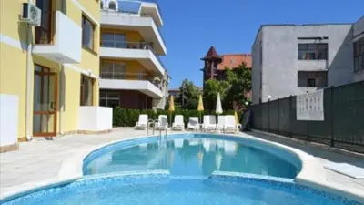 a swimming pool in front of a building at SP Luxury Loft 28 in Ravda