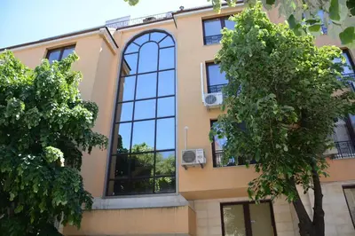 a building with large windows on the side of it at Vazov Residence , two bedroom top centre apartment in Varna City
