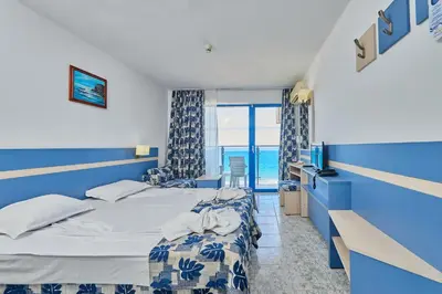 a hotel room with a bed and a window at Palace Hotel - Half Board in Sunny Beach