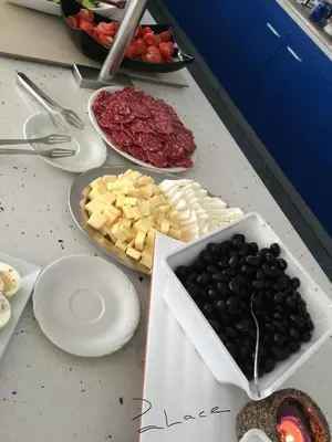 a counter top with cheese and olives and other foods at Palace Hotel - Half Board in Sunny Beach