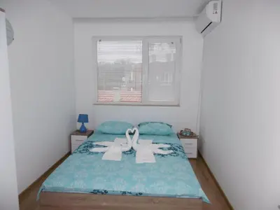 a bedroom with a bed with two towels on it at Апартамент Жекови in Tsarevo
