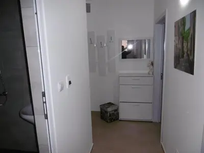 a white bathroom with a sink and a mirror at Апартамент Жекови in Tsarevo