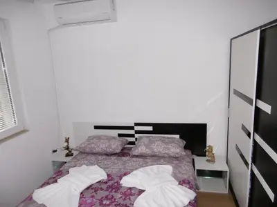 a bedroom with a bed with two pillows at Апартамент Жекови in Tsarevo