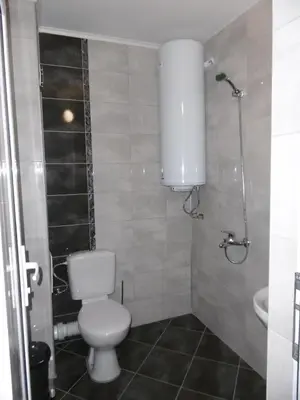 a bathroom with a toilet and a sink and a shower at Апартамент Жекови in Tsarevo