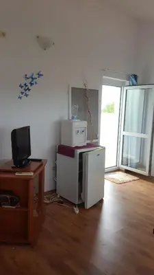 a room with a computer and a desk with a television at Penthaus Cacao Beach in Sunny Beach