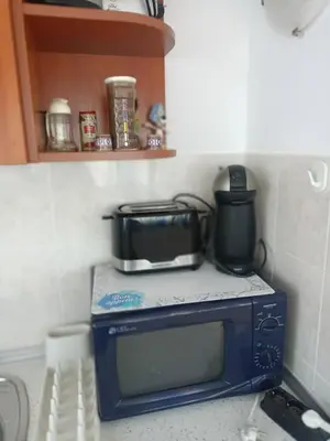 a microwave oven with a pot on top of it at Penthaus Cacao Beach in Sunny Beach