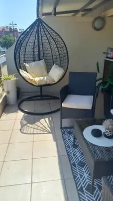 a balcony with a chair and a swing at Guest house Veneta in Sozopol