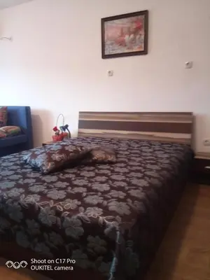 a bedroom with a large bed with a blanket at Guest house Veneta in Sozopol