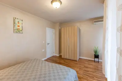 a bedroom with a bed and a hallway with a door at Blue Тerrace Apartment Top Center in Varna City