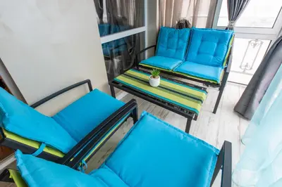 a group of blue chairs and a table on a balcony at Blue Тerrace Apartment Top Center in Varna City